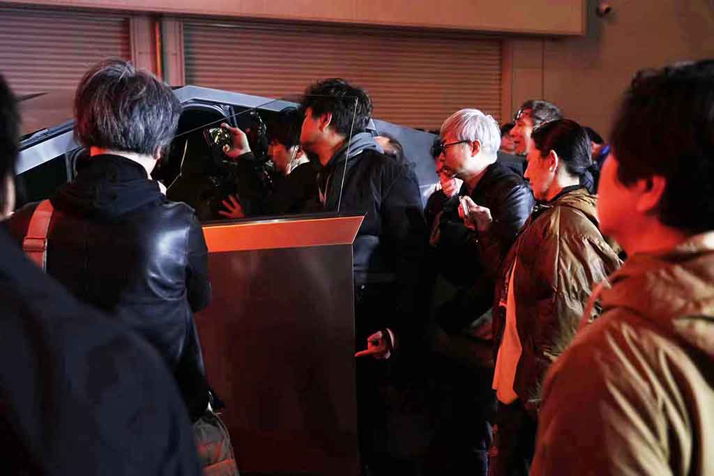 Visitors checking Tesla Cybertruck during exhibition Tour in Tokyo